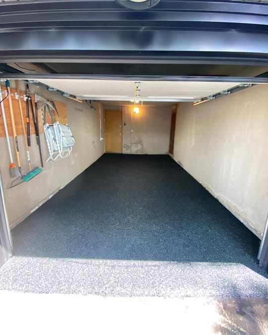 A garage floor finished in solid black Gator Grip rubber surfacing