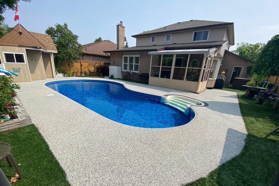 The same pool deck after Gator Grip: one continuous pearl-white rubber surface with no seams